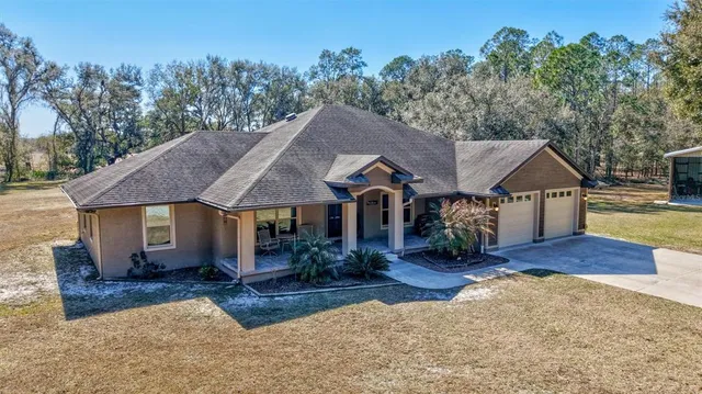 a aerial view of a house next to a big yard