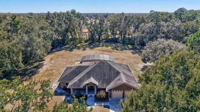 a large kitchen with stainless steel appliances granite countertop a stove a sink and a refrigerator