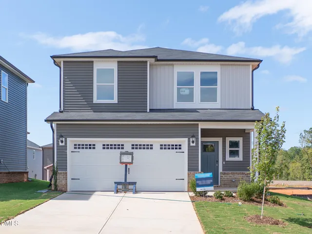 a view of a house with a yard and plants