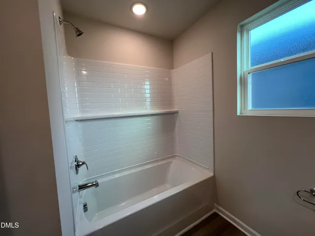 a bathroom with a double vanity sink toilet and mirror