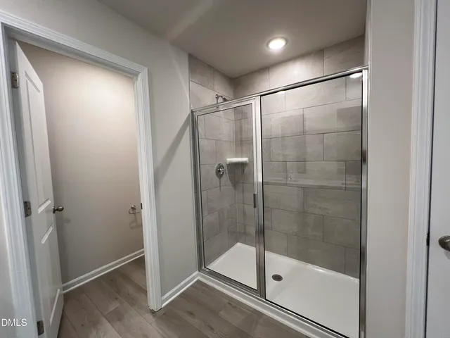 a bathroom with a glass shower door