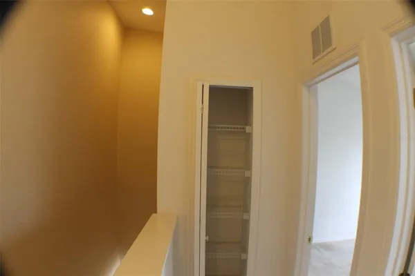 an empty room with an entryway and wooden floor