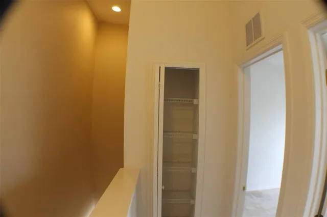 an empty room with an entryway and wooden floor