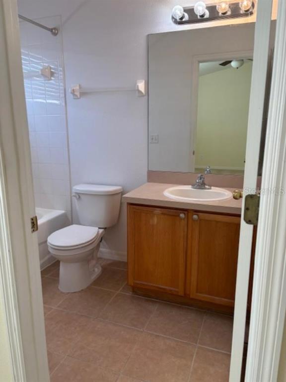 3336 Santa Rita Lane Land O Lakes, FL 34639 - Photo 26 of 60 a bathroom with a sink a toilet and a mirror