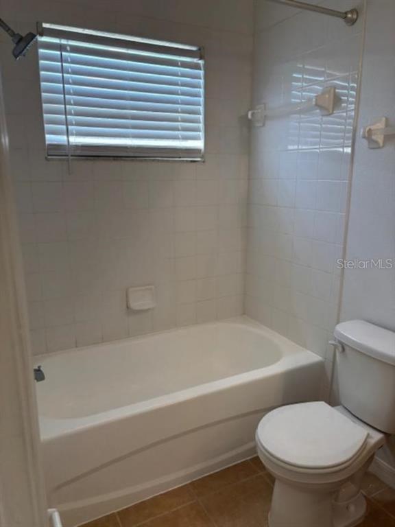 3336 Santa Rita Lane Land O Lakes, FL 34639 - Photo 36 of 60 a bathroom with a toilet and a bathtub