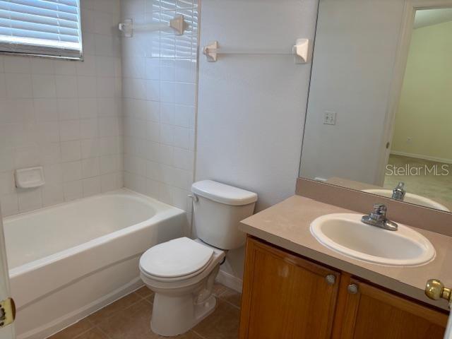 3336 Santa Rita Lane Land O Lakes, FL 34639 - Photo 44 of 60 a bathroom with a sink a toilet and a bathtub