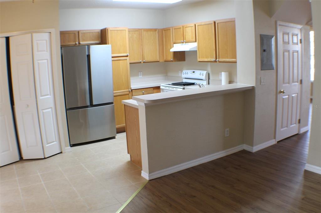3336 Santa Rita Lane Land O Lakes, FL 34639 - Photo 49 of 60 a kitchen with a refrigerator sink and cabinets