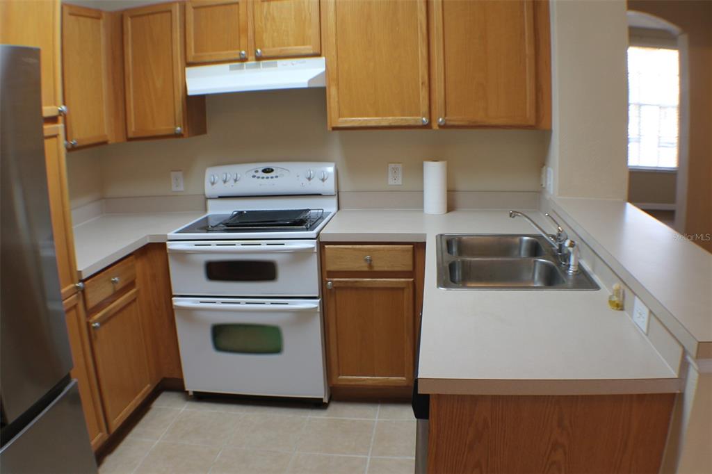 3336 Santa Rita Lane Land O Lakes, FL 34639 - Photo 51 of 60 a kitchen with a stove and a microwave