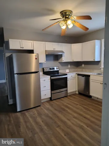 a kitchen with a refrigerator and a stove