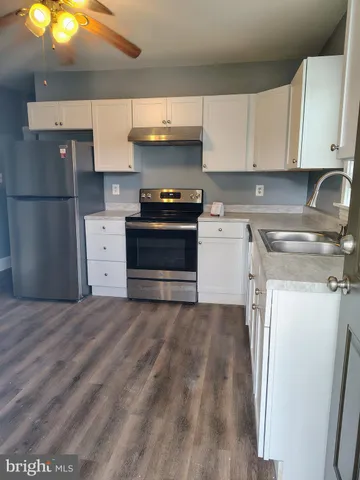 a kitchen with a stove and a refrigerator