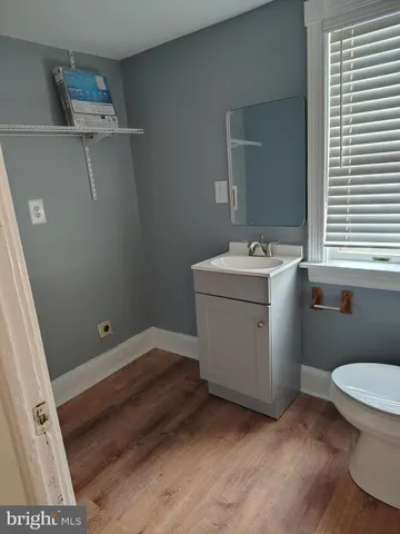 a bathroom with a sink a toilet and mirror