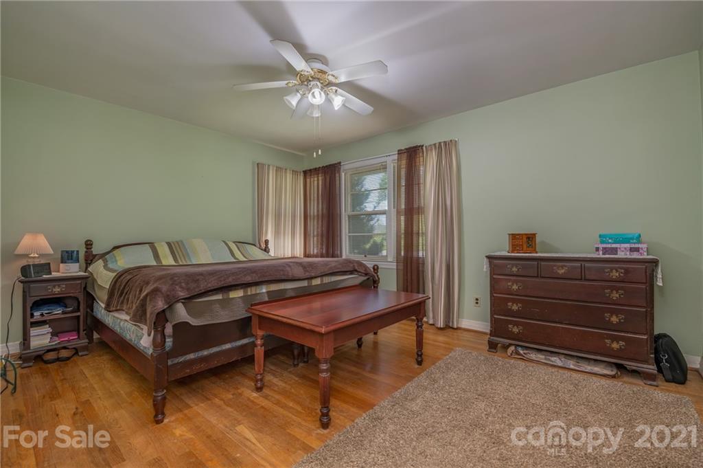 134 Chimney Rock Road Rutherfordton, NC 28139 - Photo 22 of 33 a bedroom with a bed and a chandelier