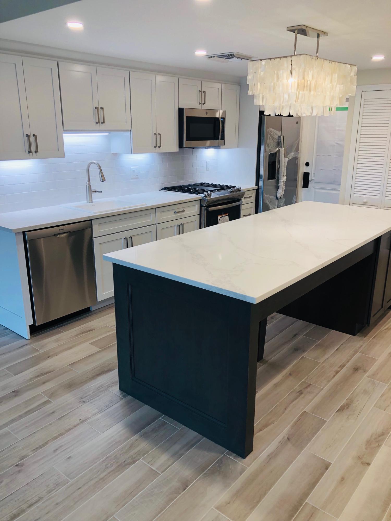 200 East Royal Palm Road, Unit 4110 Boca Raton, FL 33432 - Photo 2 of 17 a kitchen with a sink a microwave and cabinets
