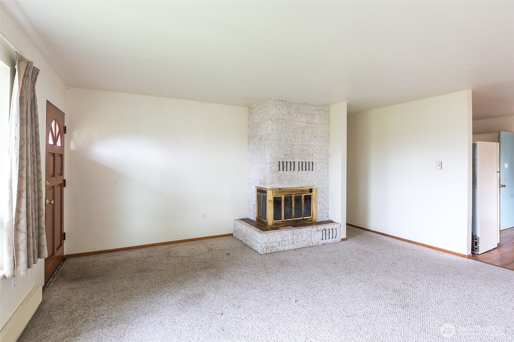 910 East 7th Street Port Angeles, WA 98362 - Photo 2 of 33 a view of an empty room with a fireplace and a window