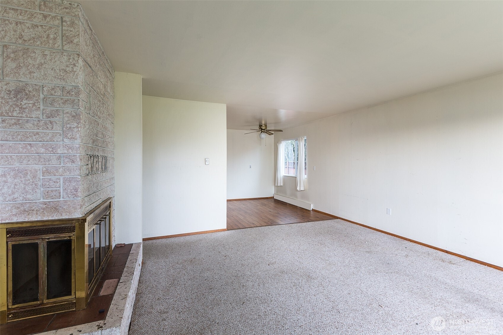 910 East 7th Street Port Angeles, WA 98362 - Photo 4 of 33 a view of an empty room with a fireplace and a window