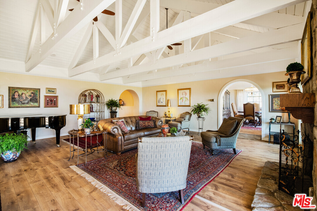 210 Lorine Lane Malibu, CA 90265 - Photo 16 of 48 a living room with lots of furniture and a rug
