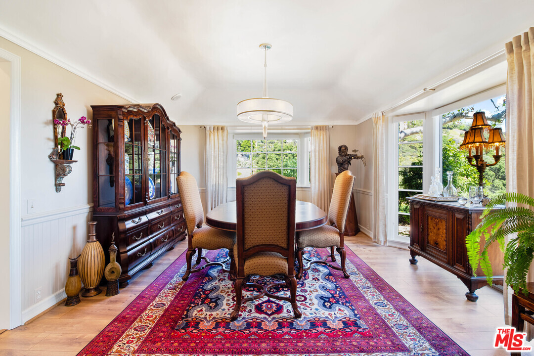 210 Lorine Lane Malibu, CA 90265 - Photo 21 of 48 a view of a dining room with furniture window and wooden floor