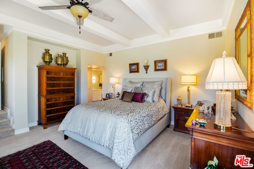210 Lorine Lane Malibu, CA 90265 - Photo 29 of 48 a bedroom with a bed and a chandelier