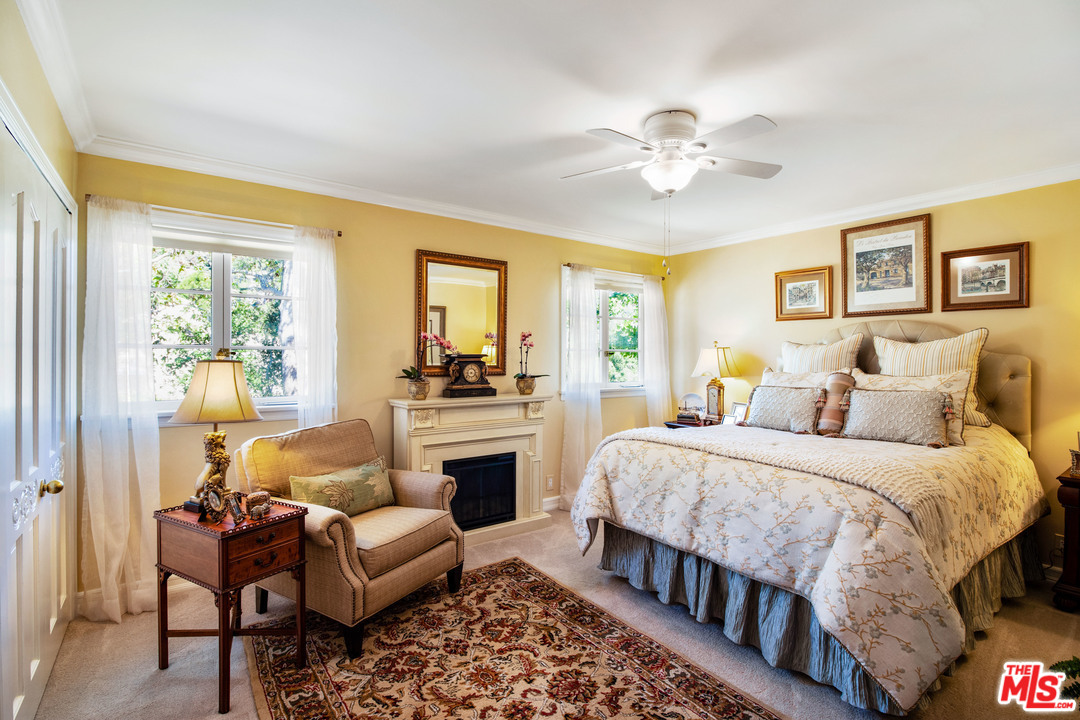 210 Lorine Lane Malibu, CA 90265 - Photo 31 of 48 a bedroom with a bed and a chandelier