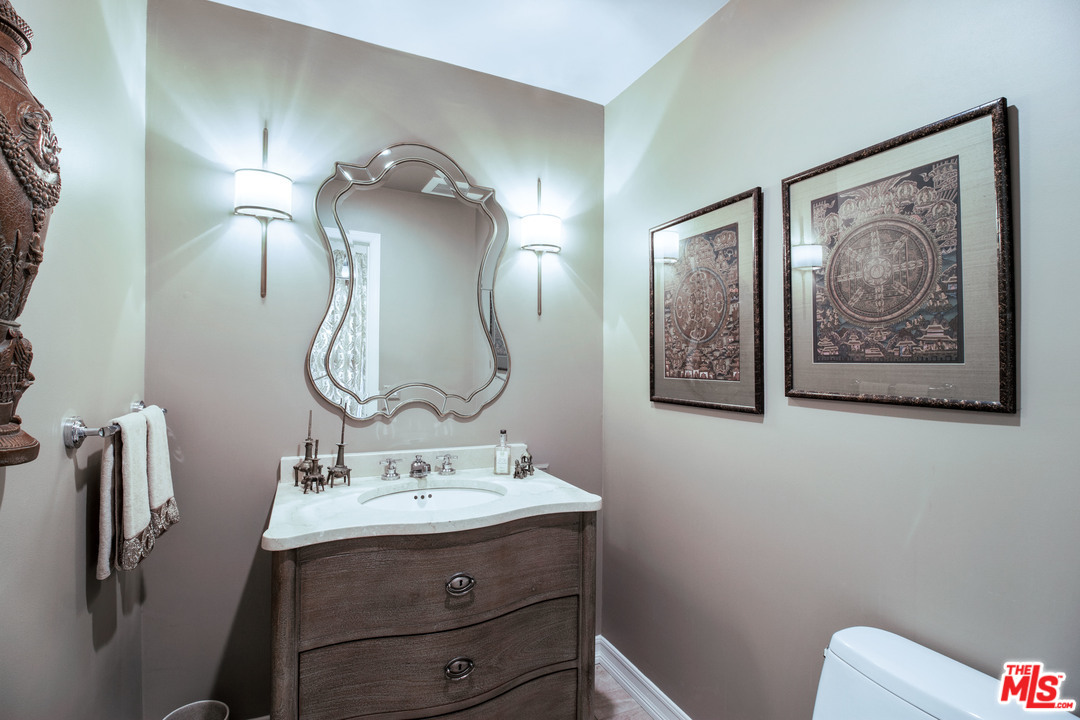 210 Lorine Lane Malibu, CA 90265 - Photo 36 of 48 a bathroom with a toilet sink and mirror