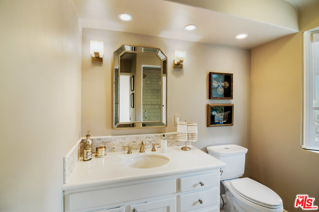 210 Lorine Lane Malibu, CA 90265 - Photo 37 of 48 a bathroom with a toilet sink and mirror