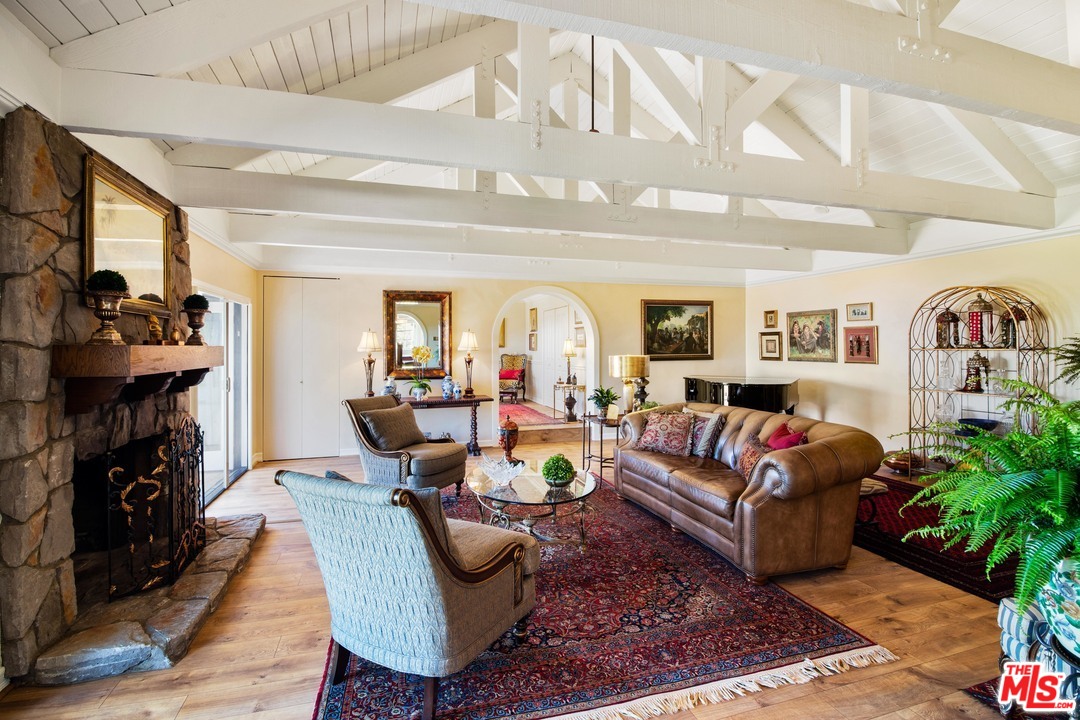 210 Lorine Lane Malibu, CA 90265 - Photo 39 of 48 a living room with furniture a fireplace and potted plants