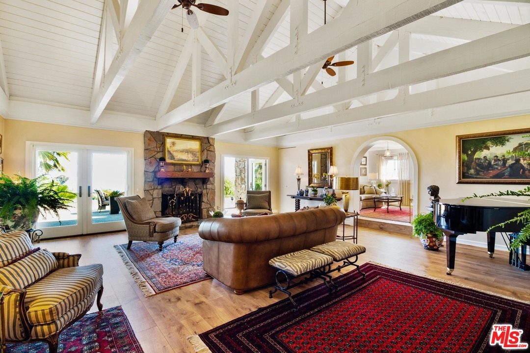 210 Lorine Lane Malibu, CA 90265 - Photo 5 of 48 a living room with furniture a fireplace and a potted plant