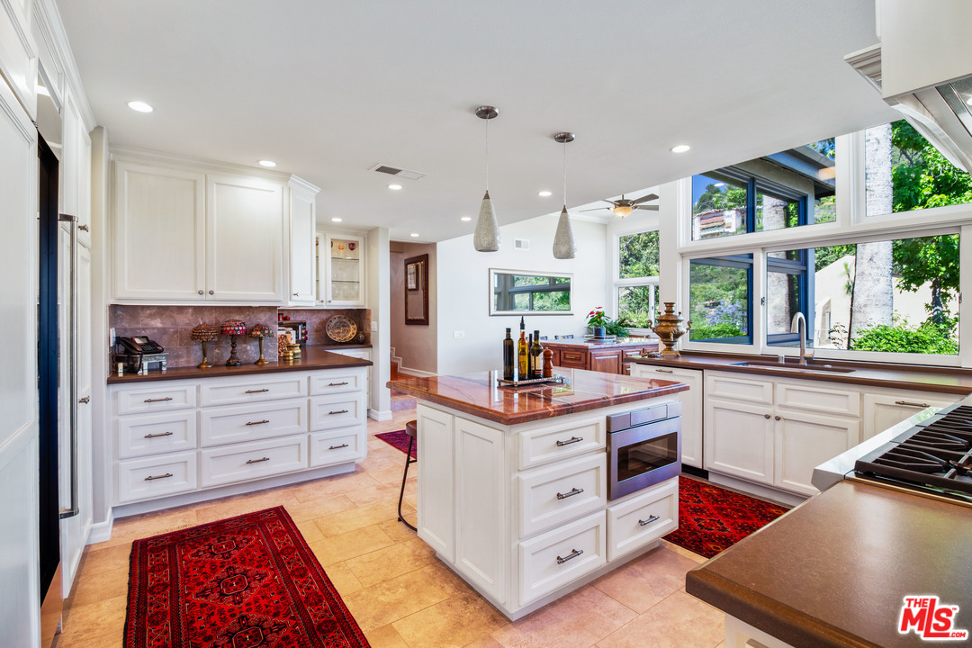 210 Lorine Lane Malibu, CA 90265 - Photo 42 of 48 a kitchen with a stove a sink and a refrigerator