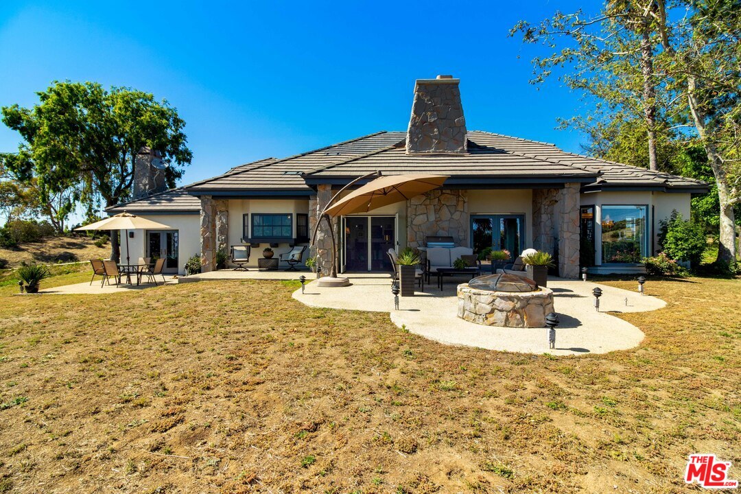 210 Lorine Lane Malibu, CA 90265 - Photo 46 of 48 a view of a patio with swimming pool table and chairs