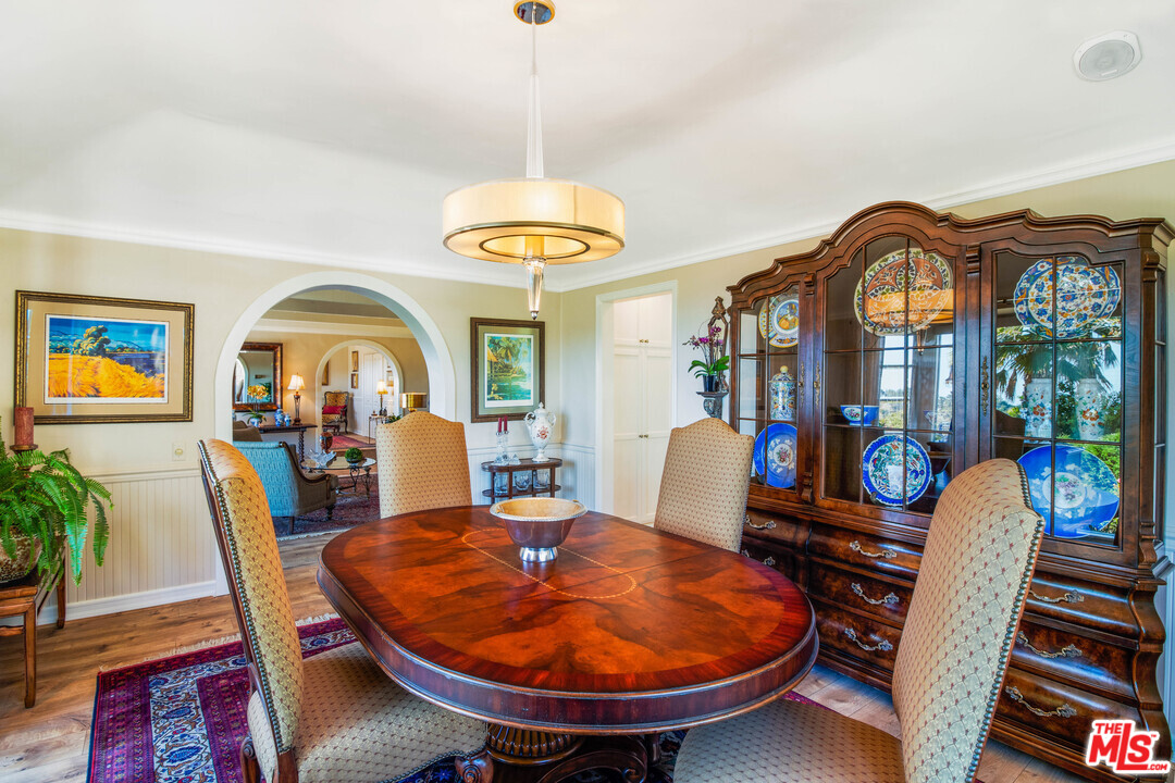 210 Lorine Lane Malibu, CA 90265 - Photo 7 of 48 a view of a dining room with furniture a chandelier and wooden floor