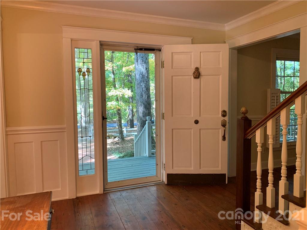 6907 Old Ridge Road Waxhaw, NC 28173 - Photo 3 of 23 a view of a hallway with wooden floor and stairs