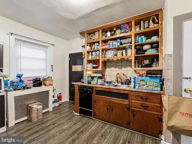 a room with a workspace and a bookshelf