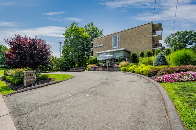 a view of a house with a yard and a garden