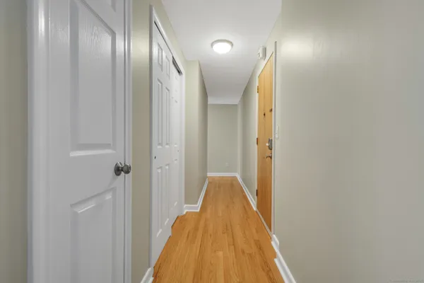 a view of a hallway with wooden floor