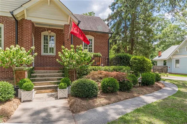 a front view of a house with garden
