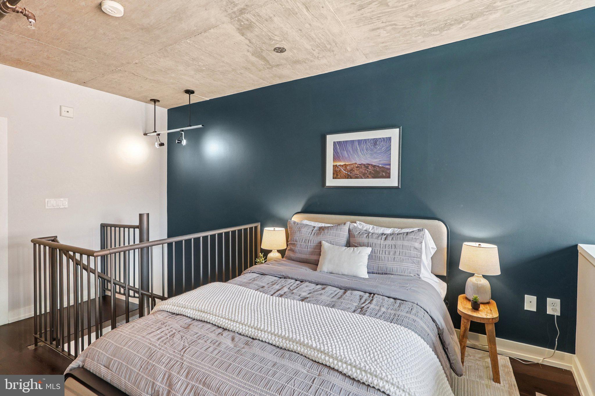 1515 15th Street Northwest, Unit 406 Washington, DC 20005 - Photo 12 of 26 a bedroom with bed and wooden floor