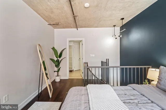 a bedroom with furniture and a wooden floor