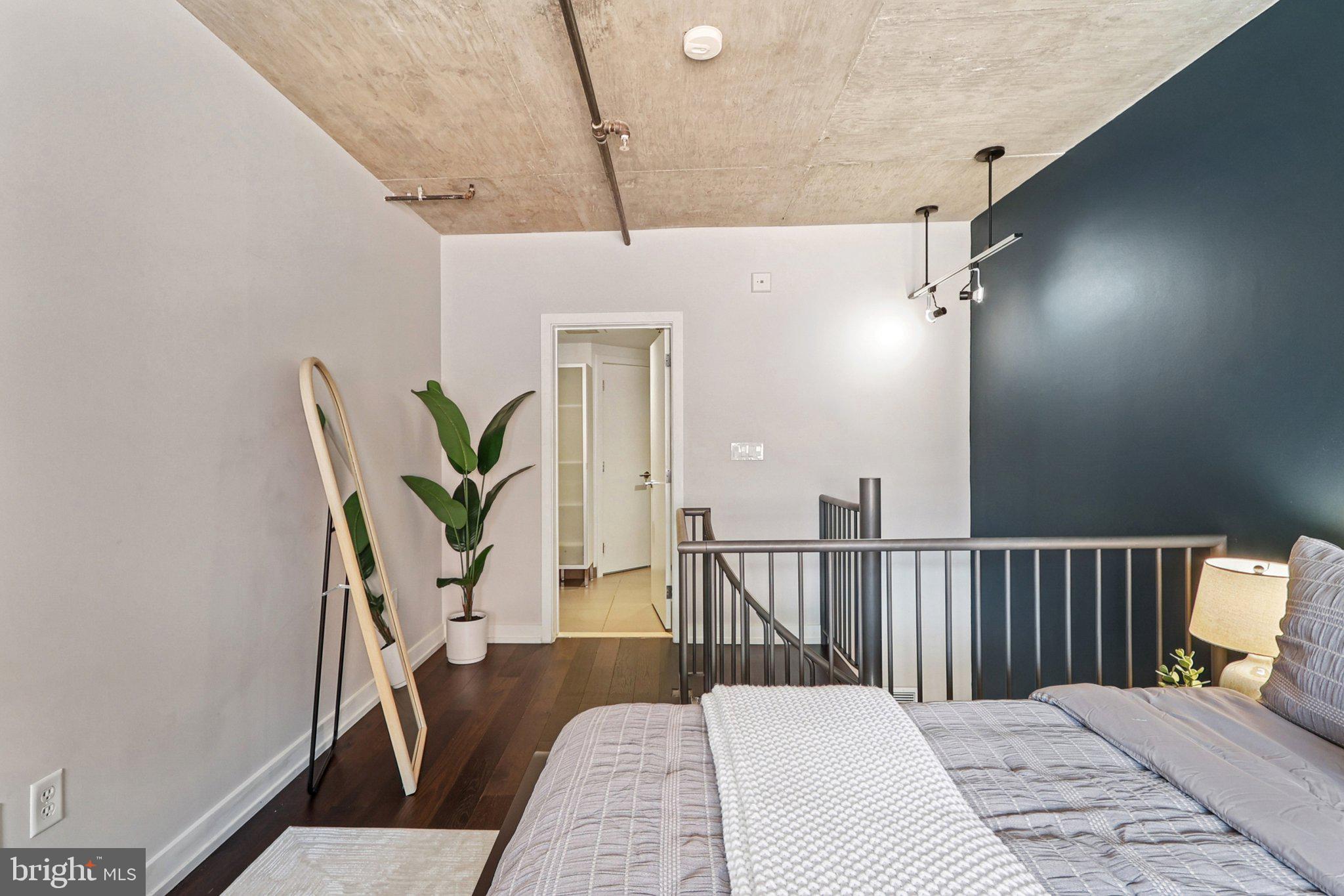 1515 15th Street Northwest, Unit 406 Washington, DC 20005 - Photo 13 of 26 a bedroom with furniture and a wooden floor
