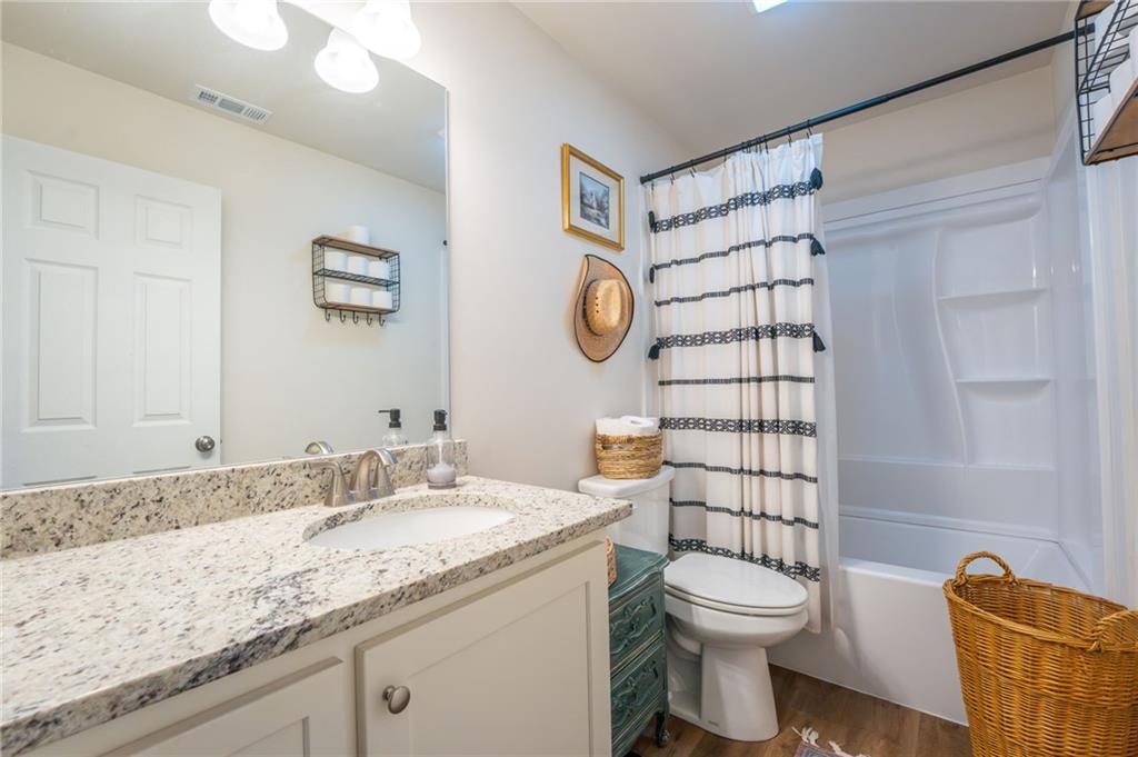118 Wash Rider Road Dahlonega, GA 30533 - Photo 9 of 37 a bathroom with a granite countertop sink a toilet and a shower
