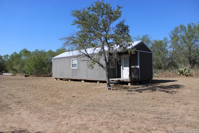 a view of a yard with a tree