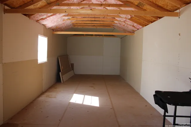 a view of a room with furniture and a potted plant