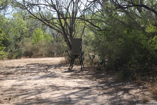 a view of dirt road with a building in the background