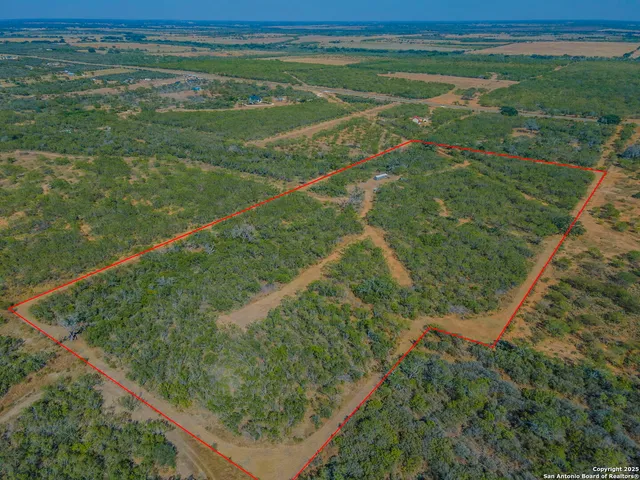 a view of a field with an ocean