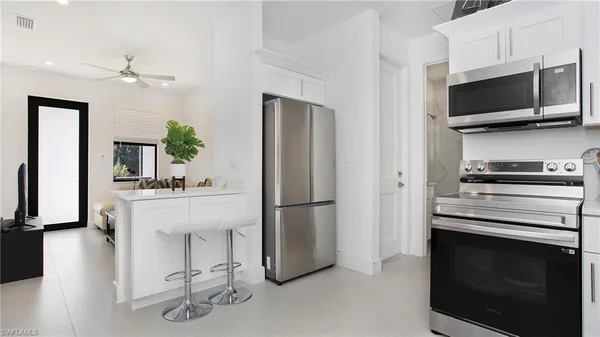 a kitchen with a refrigerator stove and microwave