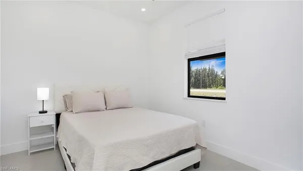 a bedroom with a bed and a night stand