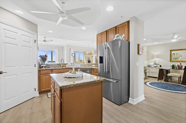 a living room with furniture a table and kitchen view