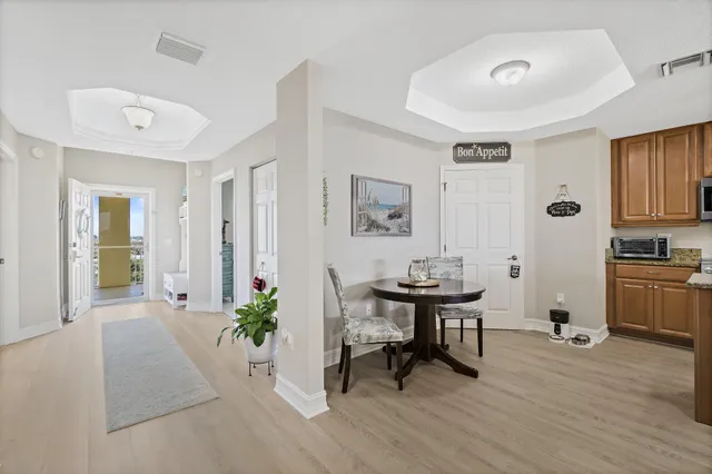 a view of a swimming pool with a lawn chairs and palm tree