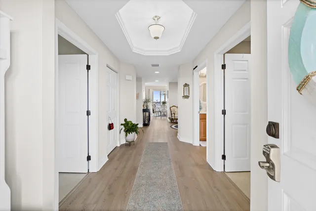 a view of a dining room with furniture a chandelier and wooden floor