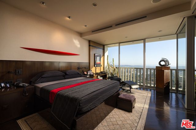a bed room with a bed and glass door
