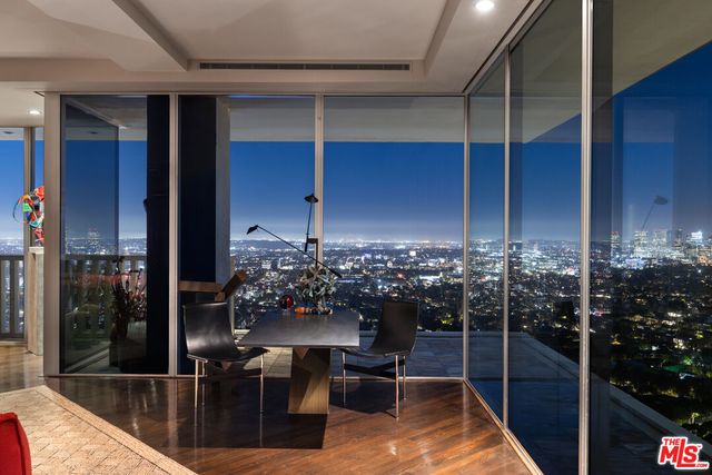 a view of a balcony dining table and chairs